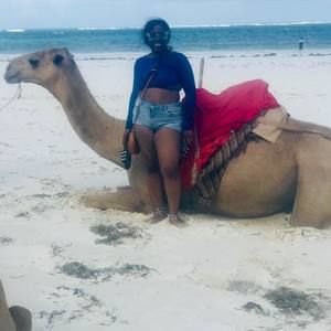 Trying on the bell bottom pants one leg at a time.